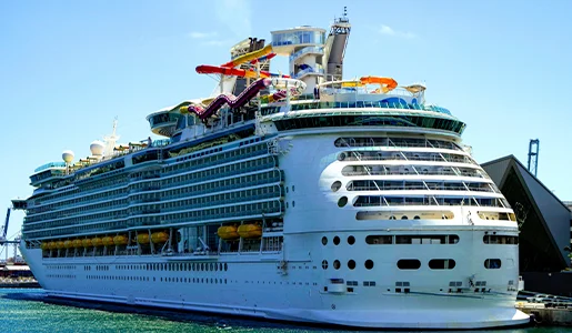 Large cruise ship docked with water slides
